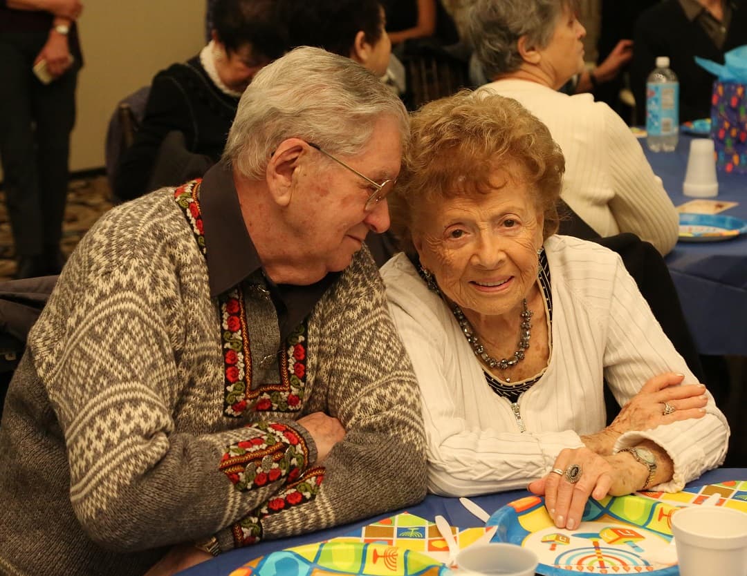 Shlomo pictured with Regina Salomon at a Chanukah party in 2015
